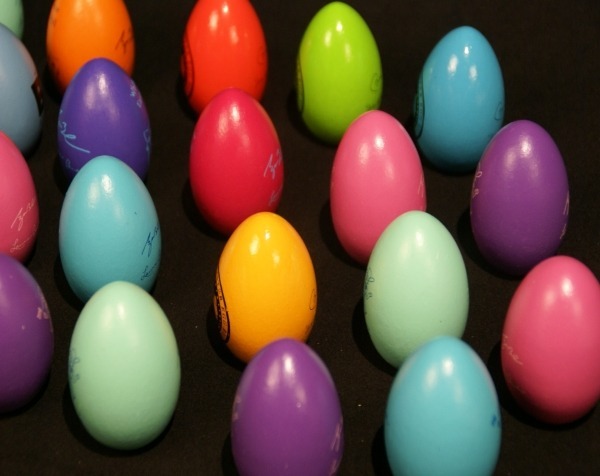 Assorted painted wooden eggs, available in bulk for manufacturers and large-scale production runs.